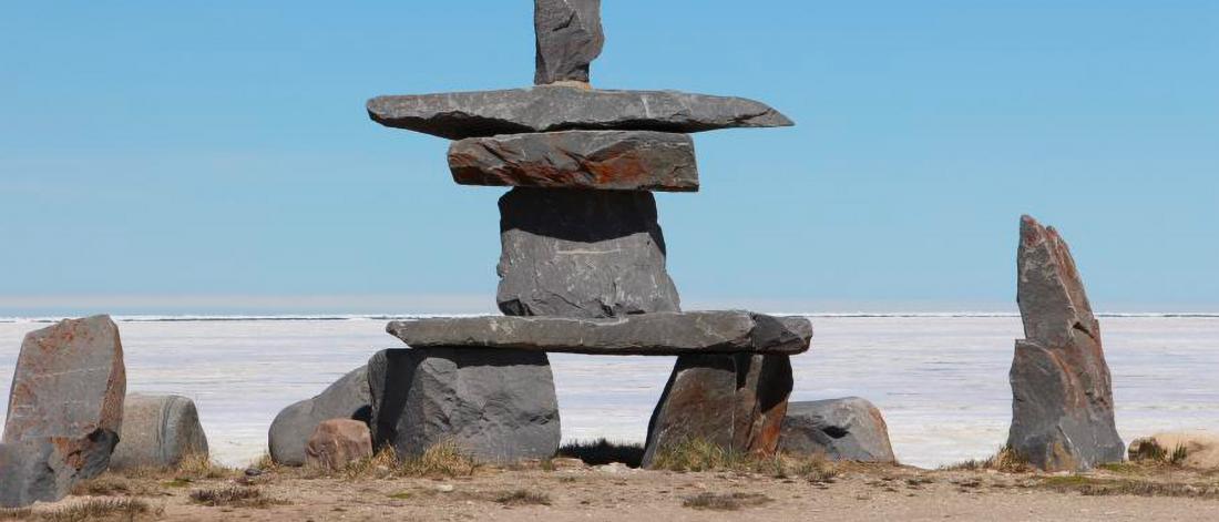 A large inukshuk constructed by stone. 