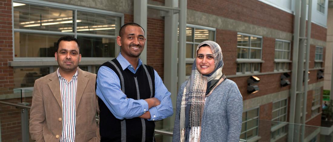 Three Internationally educated engineers qualification program students stand together.