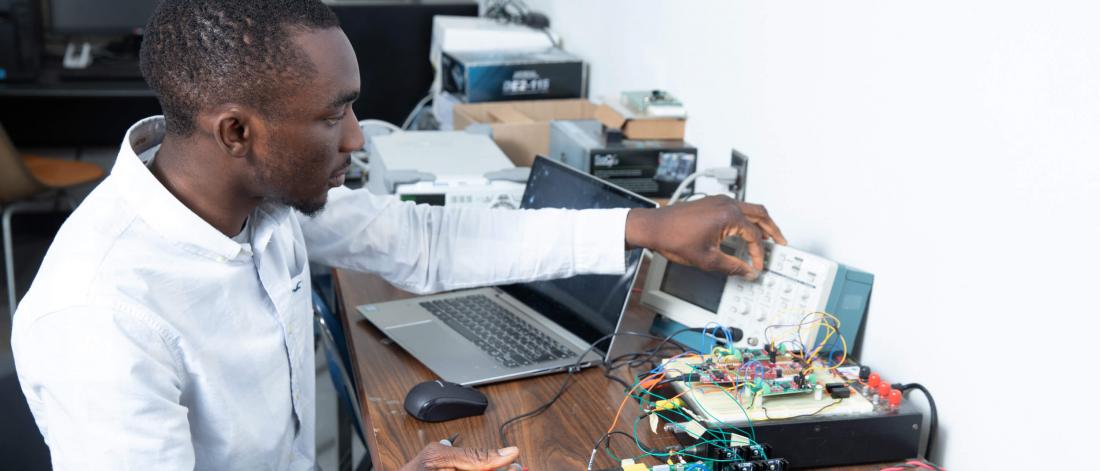 An electrical engineering student works in a lab.