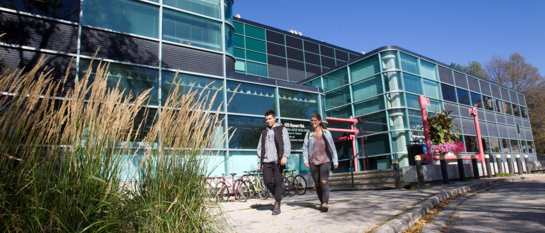 Geological sciences students walk outside the Riddell faculty of earth environment and resources building.