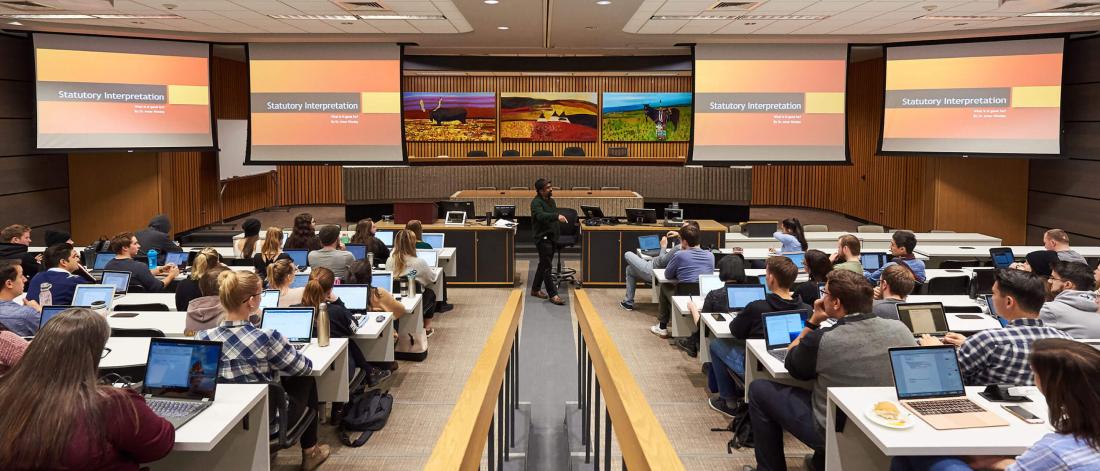 A large classroom full of students listening to a lecture.