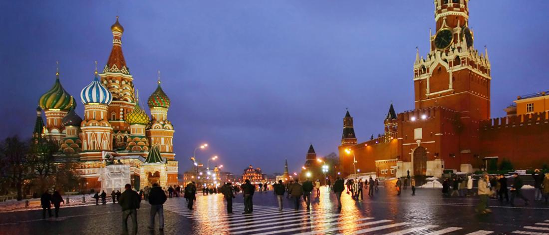 A scenic late evening view of  brightly lit buildings in Moscow.