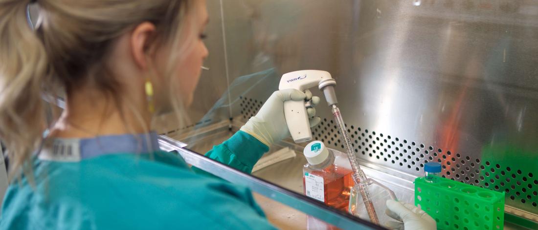 Researcher working with a test tube.