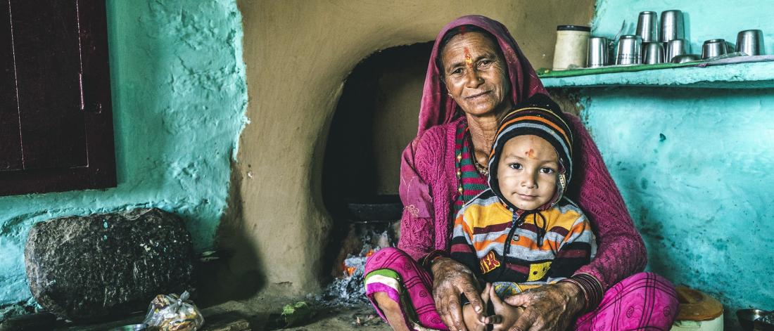 East Indian woman holding a child.