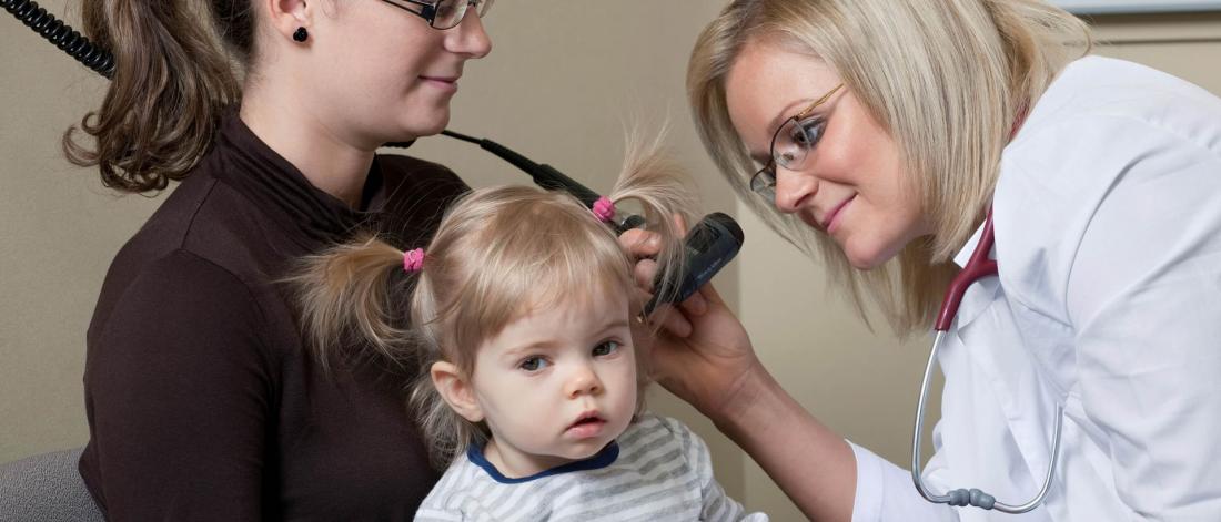 Physican examines a child's ear.