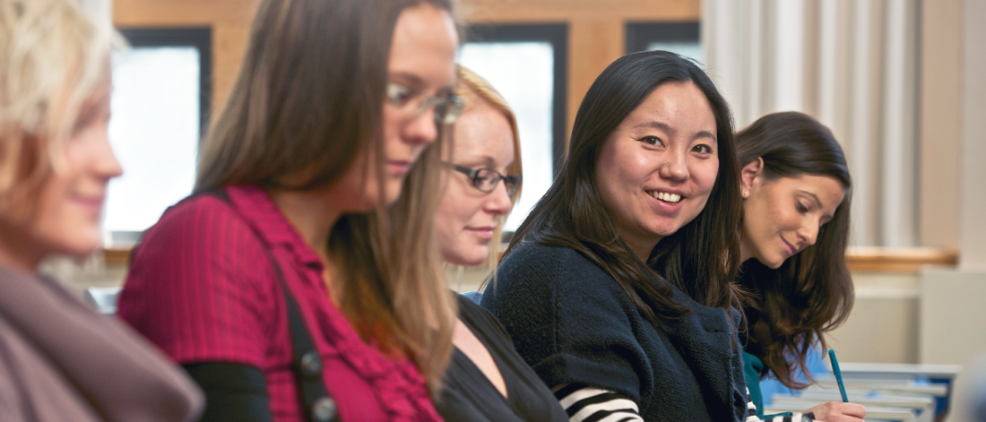 A UM student looking directly at the camera while in class.