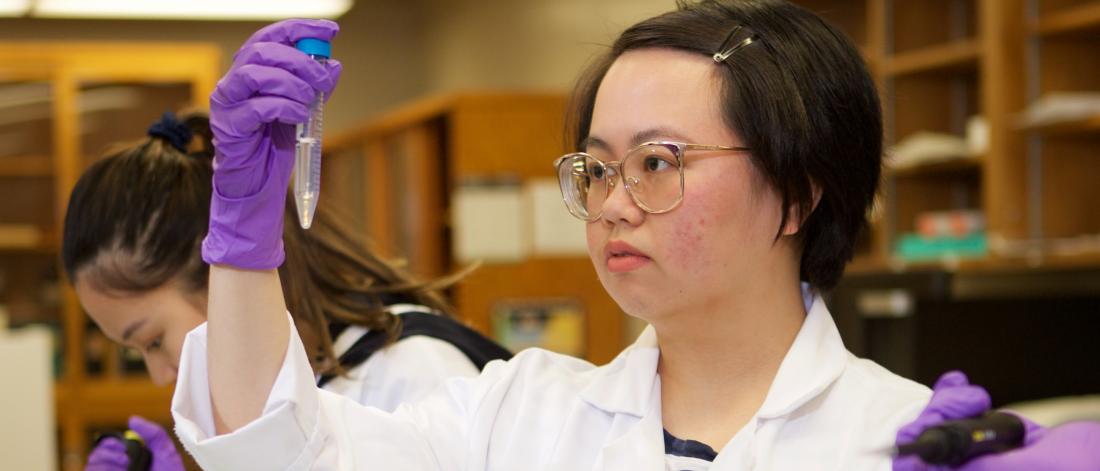Researcher working with a test tube.