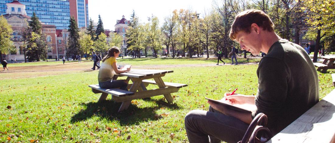 Students studying outdoors at the University of Manitoba's Fort Garry campus