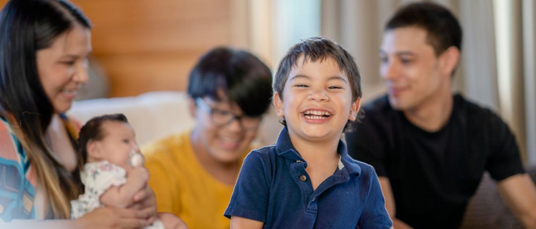 Child surrounded by family.
