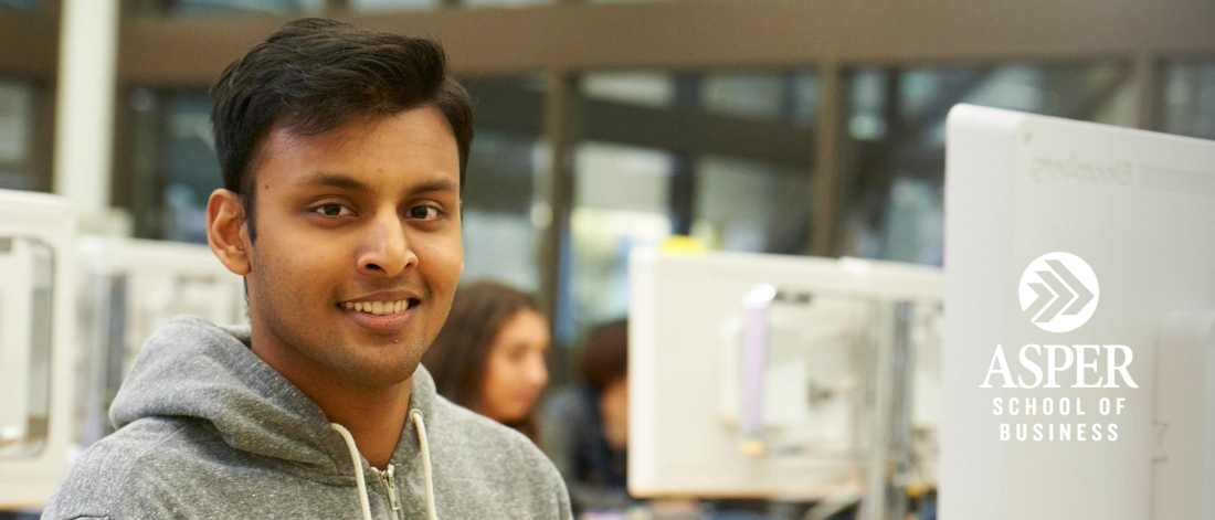 Image of a male Asper student working on a computer.