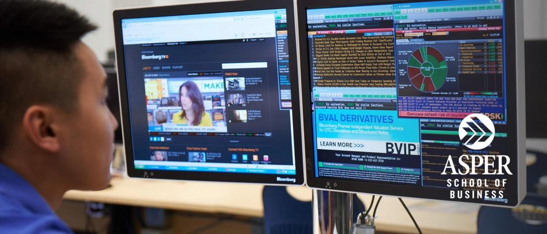 Image of an Asian student working on a Bloomberg terminal.