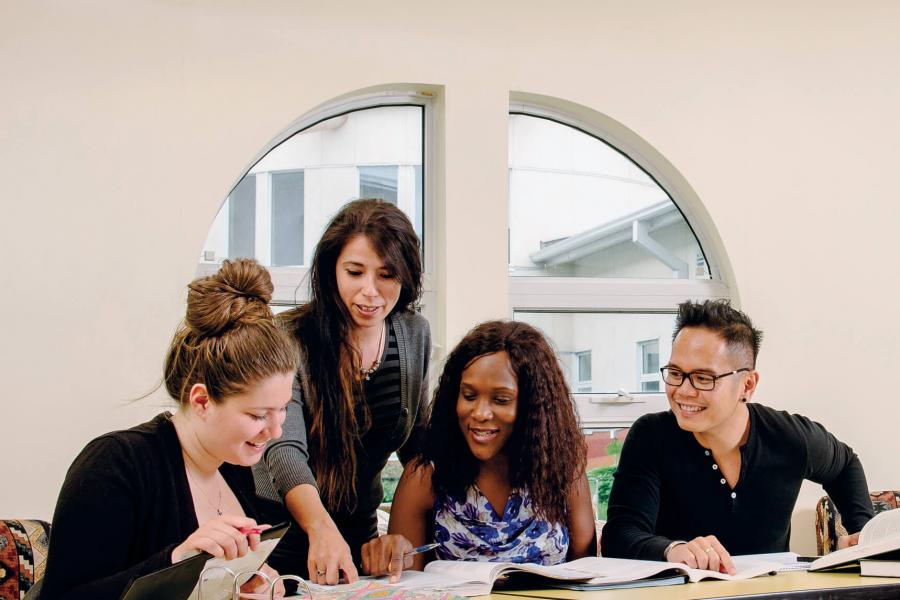 Faculty of social work students working together at a table. 