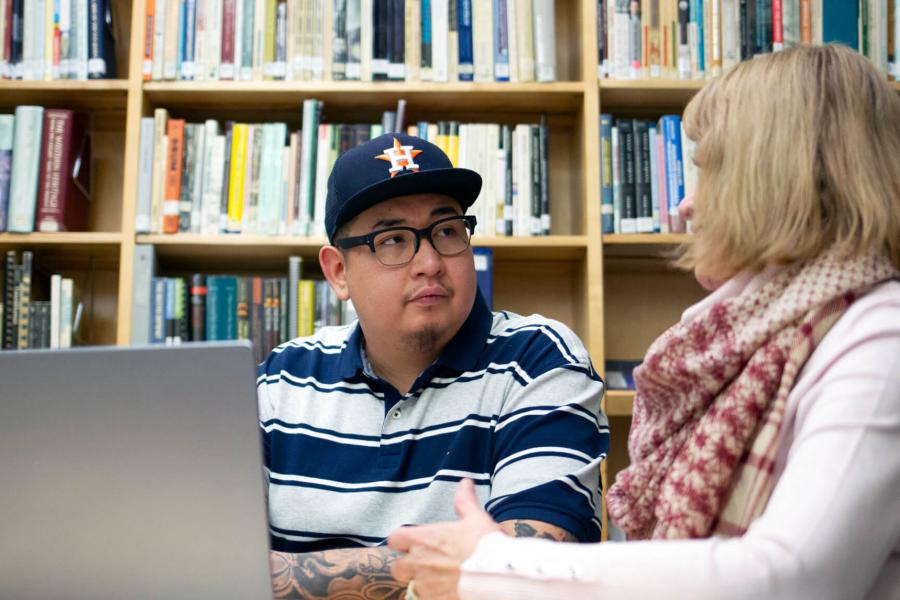 social work masters programs online canada A social work student works on research in a library.