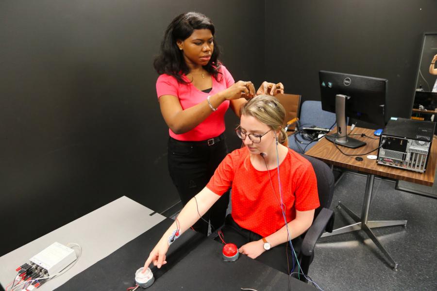 Two kinesiology undergraduate programs students working together in a lab.