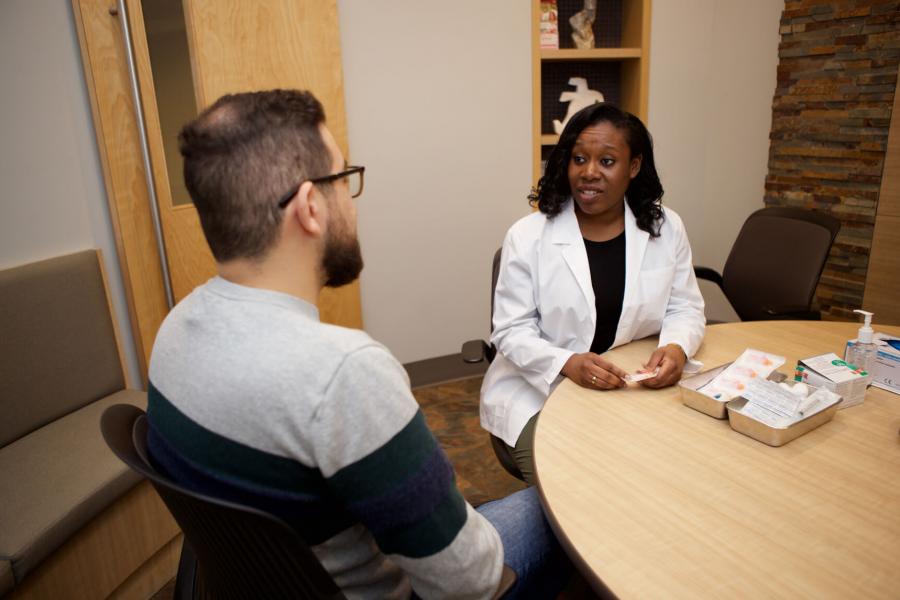 A pharmacist consults with a community member.