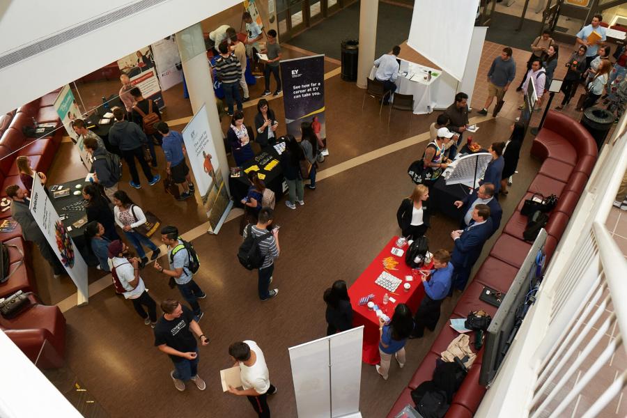 Asper students visit different information booths during an event. 