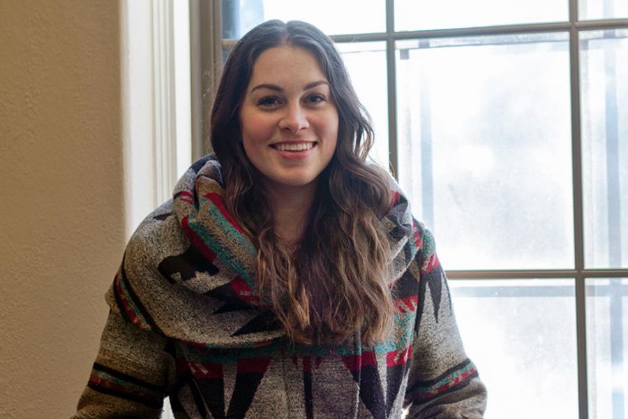 Madison Wilford a Bachelor of Recreation Management and Community Development student stands near a window.