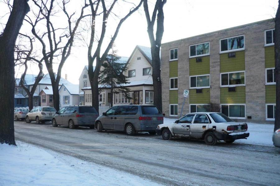 Cars parked on the street in winter.