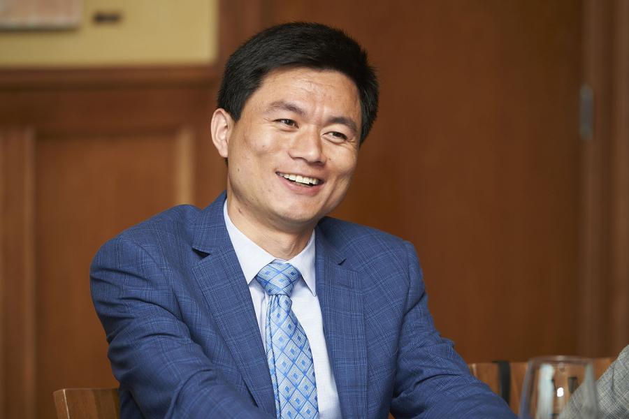 Man smiling in a suit, Asper School of Business.