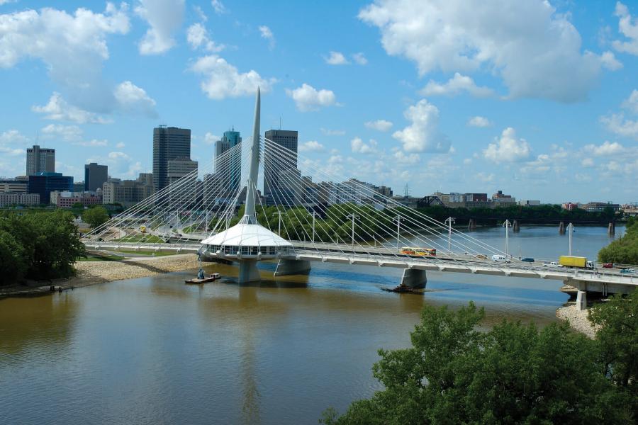 A scenic view of downtown Winnipeg overlooking the Esplanade Riel footbridge.