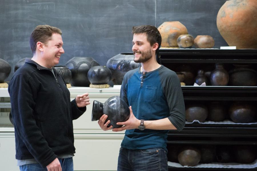 Two anthropology students stand side by side.