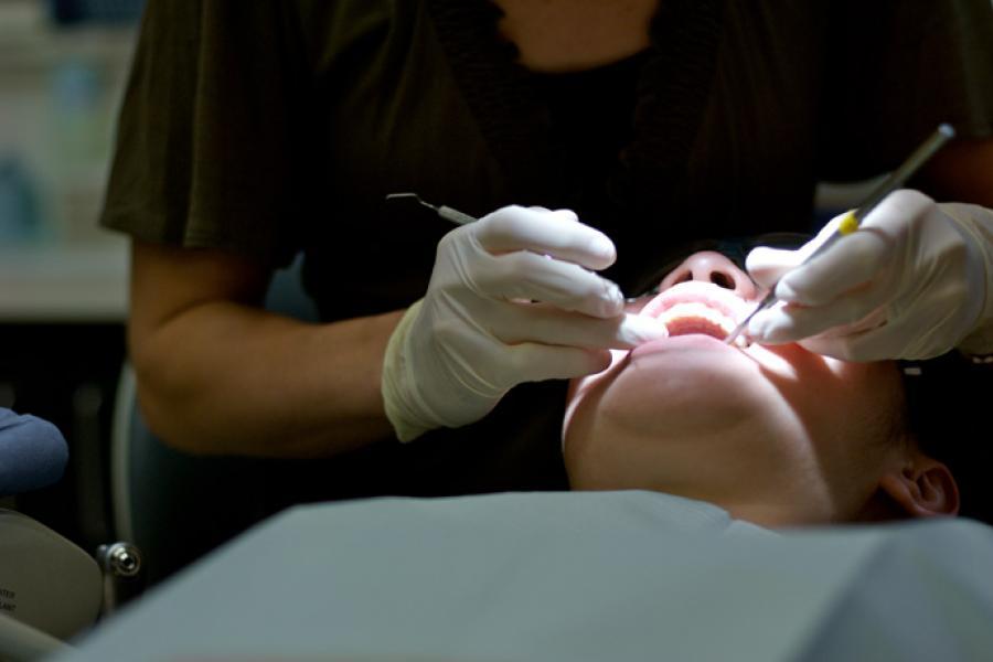 A patient receives an oral examination.