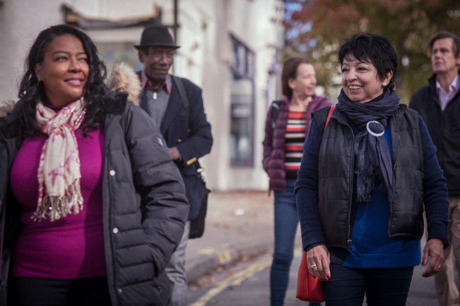 A group of older adults walking together outdoors.