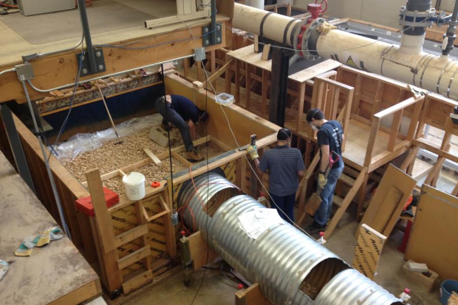 Engineering students work on building a large structure.