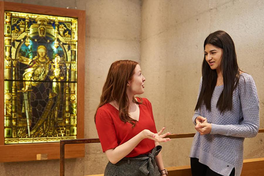 Two students speaking with eachother.