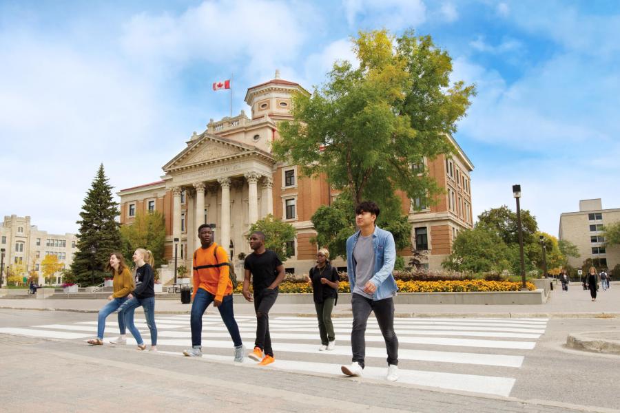 University of Manitoba students walking in front of the administration building at the Fort Garry campus.