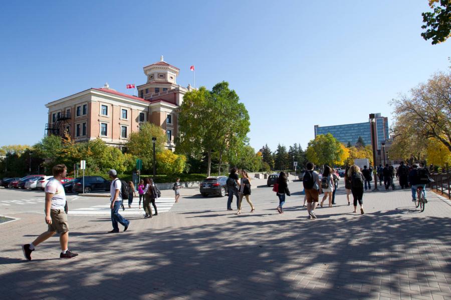 Students walking outdoors in front of the University of Manitoba Administration building at the Fort Garry campus.