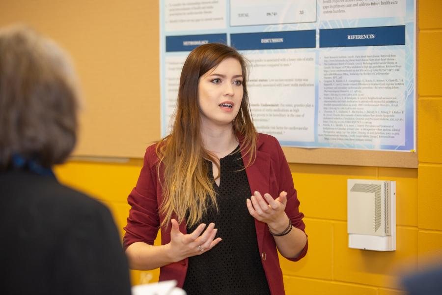 A woman speaks to a group of people