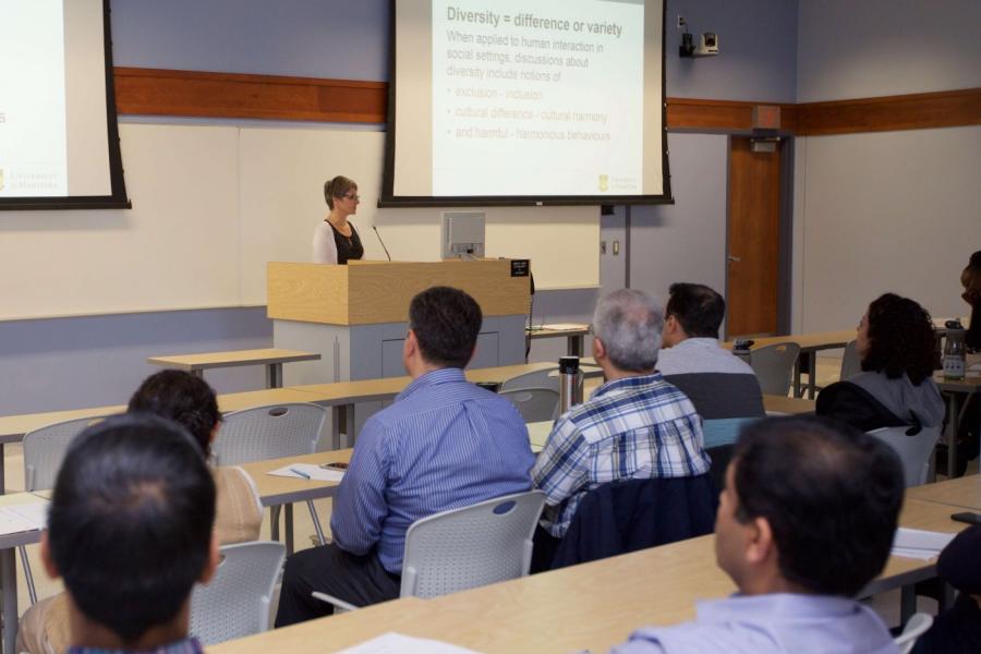 Woman presenting to group in lecture hall