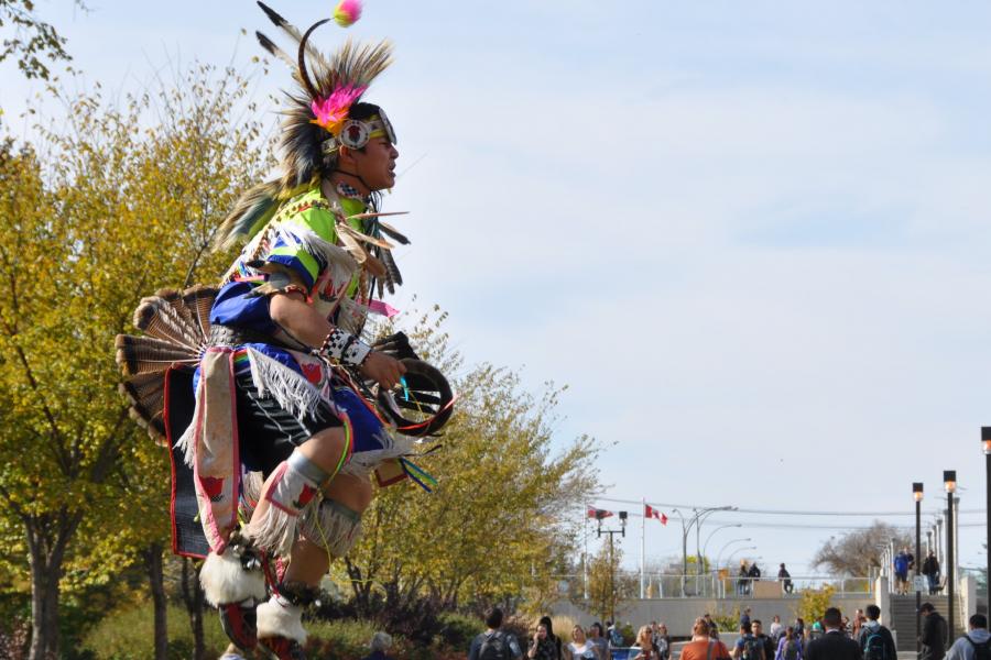 Indigenous man dancing.