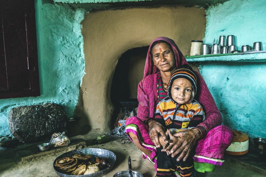 East Indian woman holding a child.