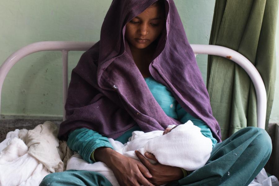 Woman holding a baby.