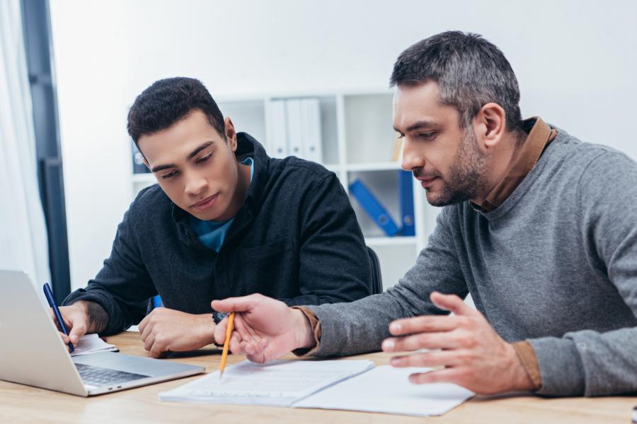 Male student working with mentor