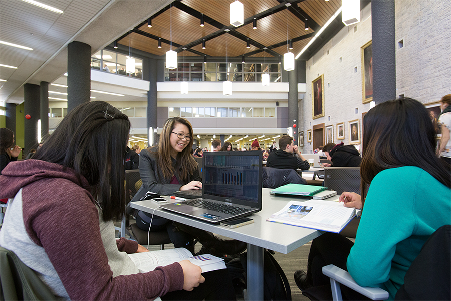 a shot of students inside the Elizabeth Dafoe Library.
