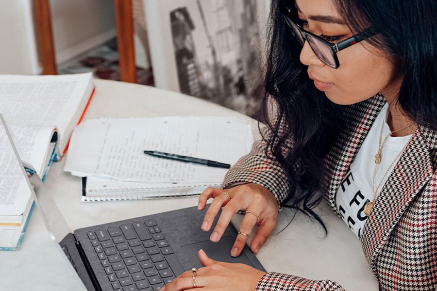 A woman working at a laptop computer.