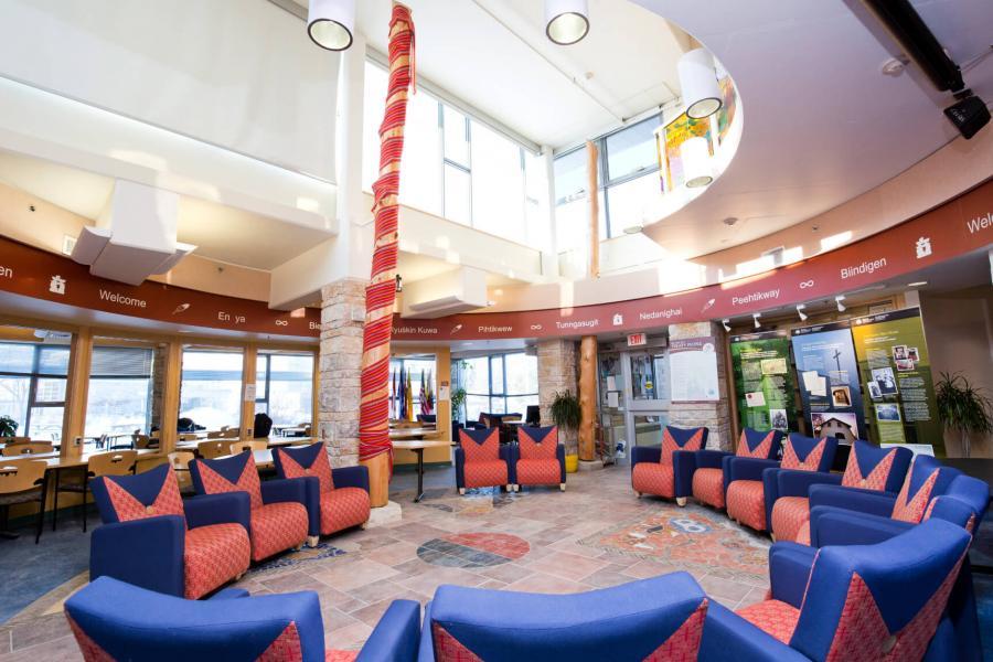 An interior view of a large circular space inside Migizii Agamik - Bald Eagle Lodge.