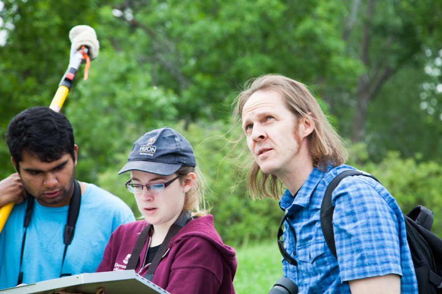 Biological sciences field research work Kevin Fraser looking up