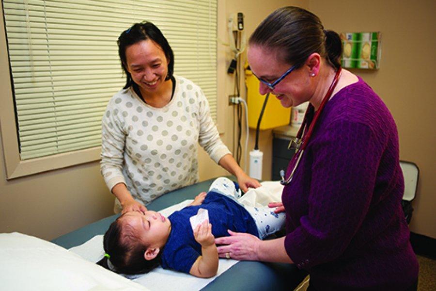 A healthcare worker examines a child.