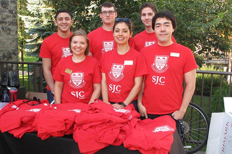 Student residents of St John's College wearing red college t-shirts.