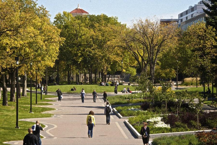 An overhead image of a part of UM Fort Garry Campus during summer, where green trees and students can be seen.