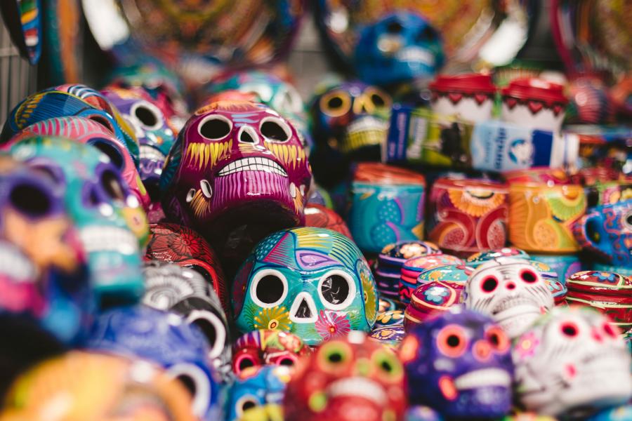 A collection of mini, multicoloured painted wooden skulls. 