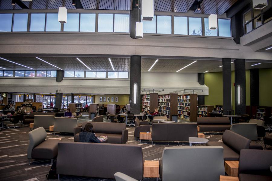 A large lounge with couches and shelves of books at the Elizabeth Dafoe Library,