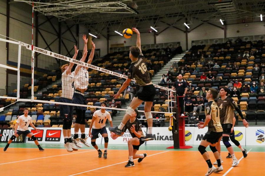 A University of Manitoba Bisons men's volleyball player spikes the ball over the next during a game at the Investors Group Athletic Centre.