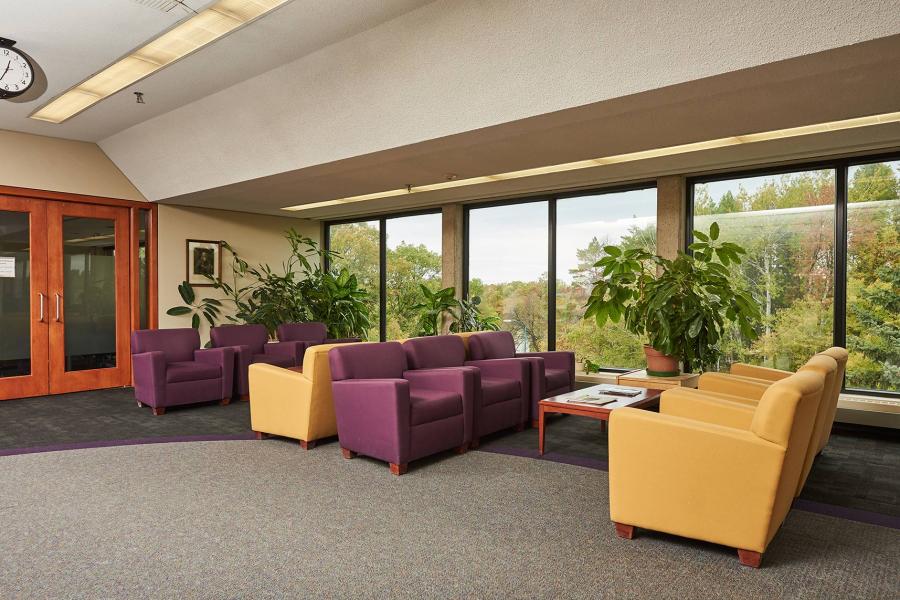 Yellow and purple couches in a sitting area of Robson Hall.