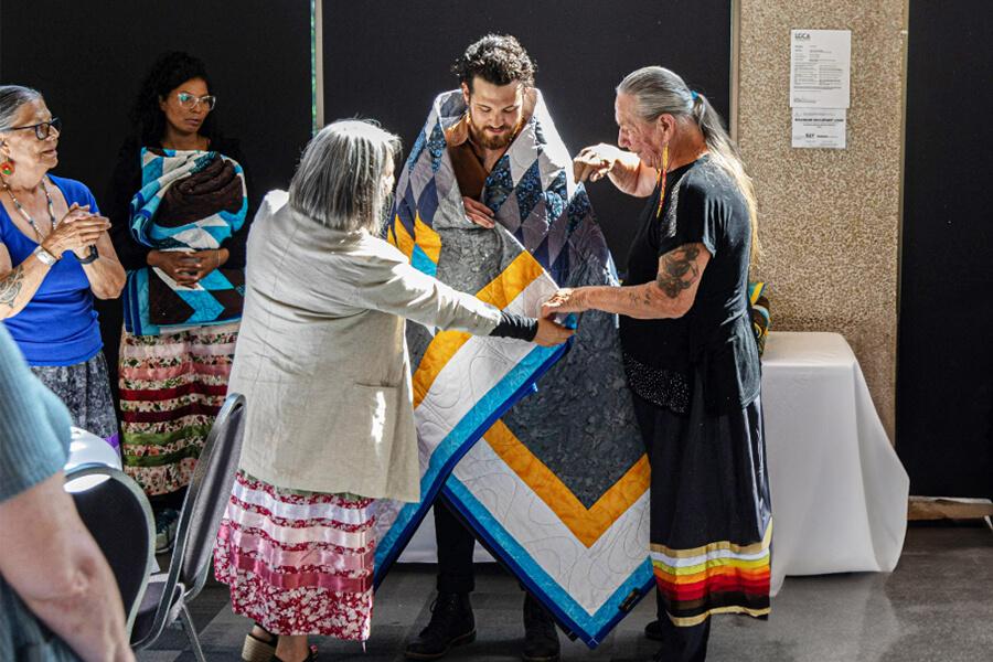 An Indigenous student participating in the blanket ceremony. 