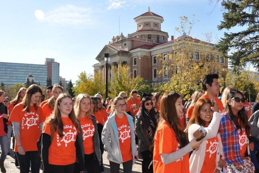 Participants of Orange Shirt Day march together at the University of Manitoba Fort Garry campus.